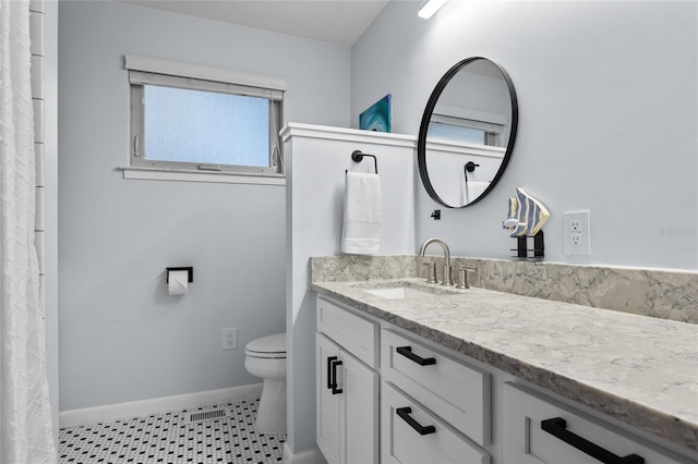 bathroom featuring tile patterned flooring, visible vents, baseboards, toilet, and vanity