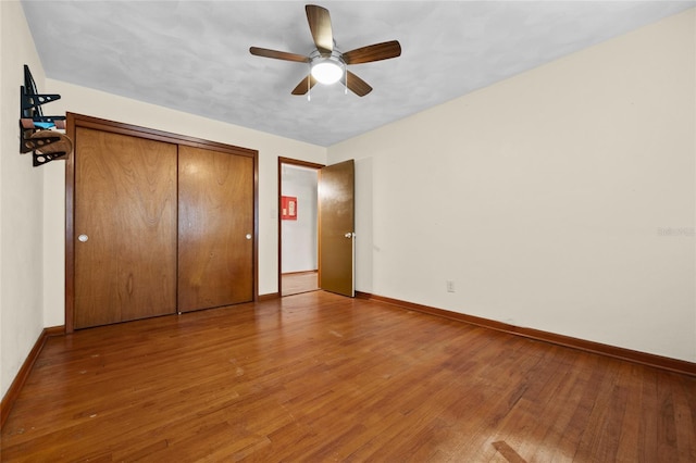 unfurnished bedroom with ceiling fan, baseboards, and hardwood / wood-style floors