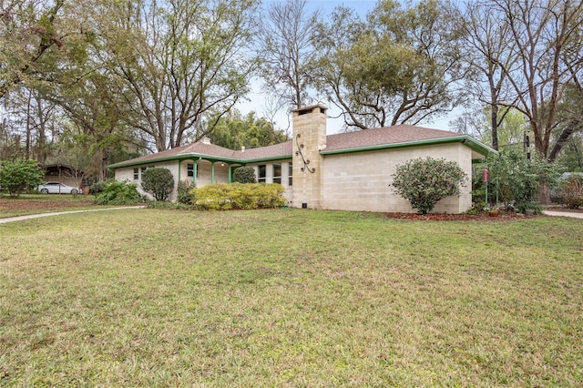 exterior space featuring a chimney and a front yard