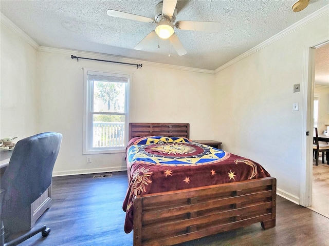 bedroom featuring visible vents, a textured ceiling, wood finished floors, and crown molding