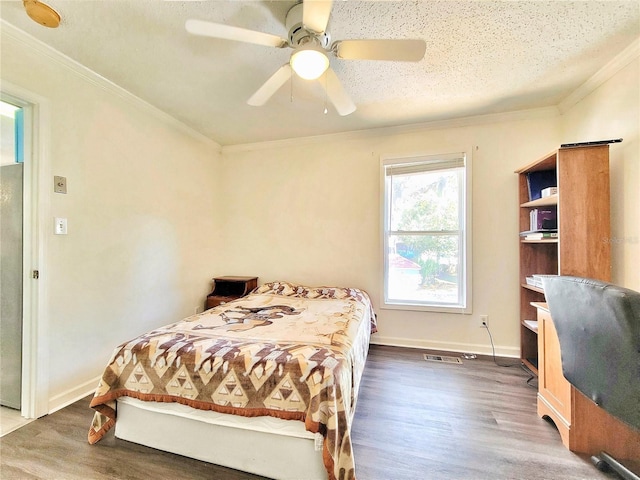 bedroom with visible vents, baseboards, crown molding, and dark wood-type flooring