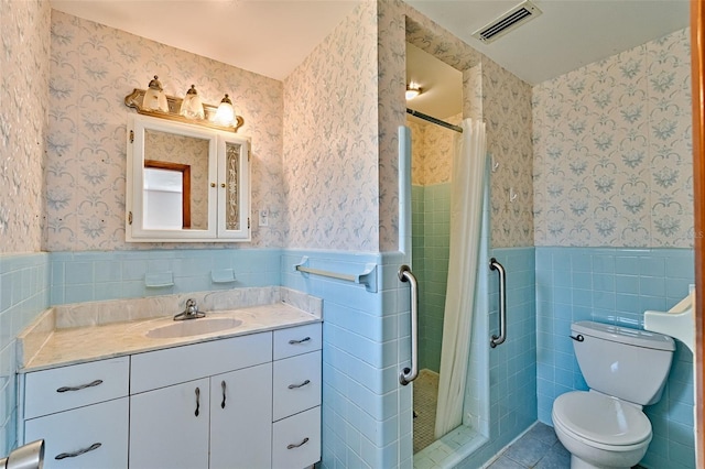 bathroom featuring a wainscoted wall, visible vents, a stall shower, and wallpapered walls