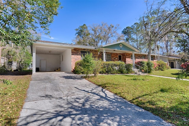 single story home with an attached carport, a front lawn, brick siding, and driveway