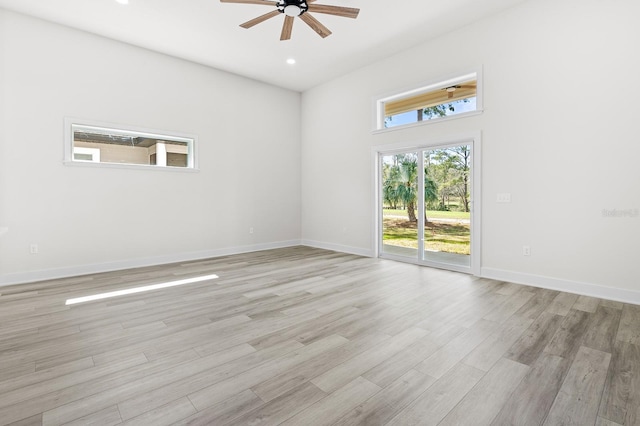 spare room with recessed lighting, a ceiling fan, light wood-type flooring, and baseboards