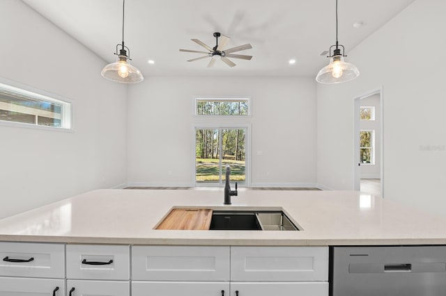 kitchen with recessed lighting, a sink, white cabinets, dishwasher, and decorative light fixtures