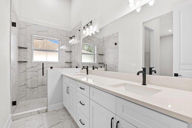 full bath featuring a marble finish shower, marble finish floor, and a sink