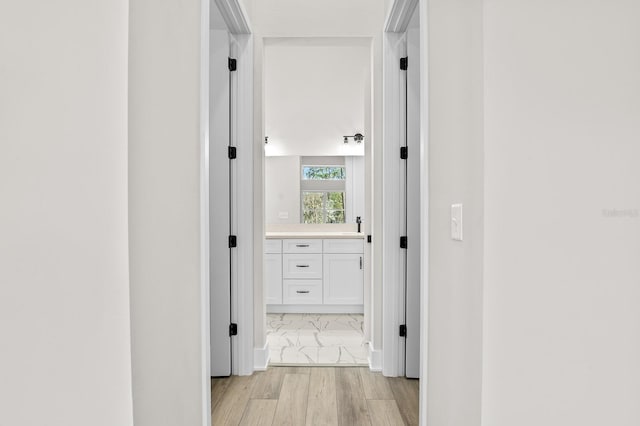 corridor with light wood-style flooring