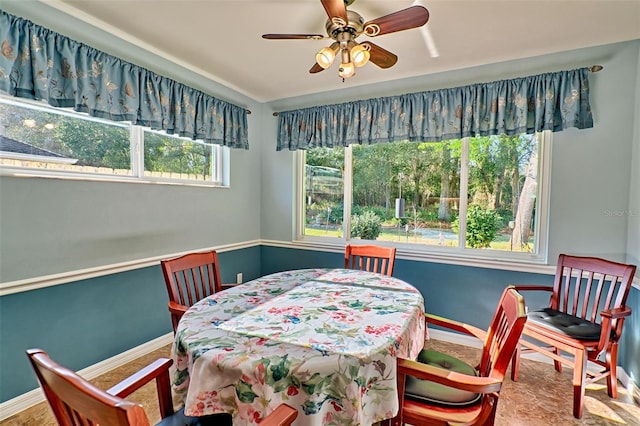 dining area featuring a ceiling fan and baseboards