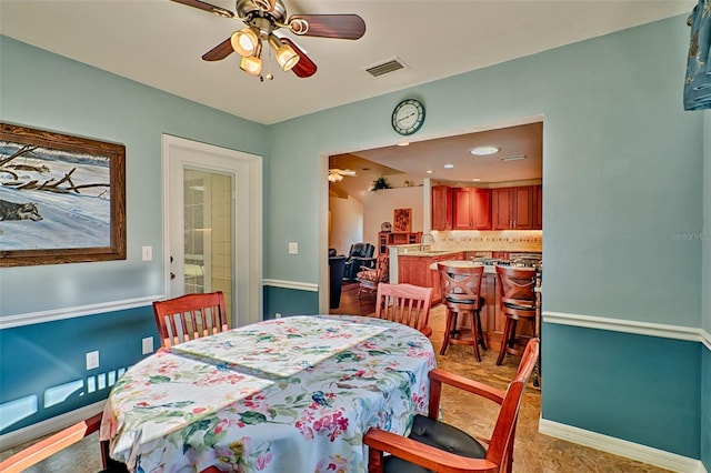 dining space featuring baseboards, visible vents, and ceiling fan