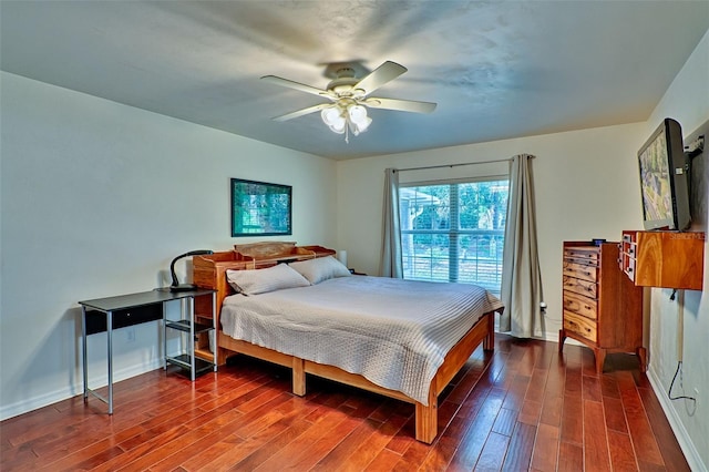 bedroom featuring baseboards, dark wood-type flooring, and a ceiling fan