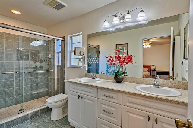 ensuite bathroom with visible vents, a shower stall, ensuite bath, and a sink