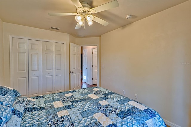 bedroom with visible vents, a closet, and ceiling fan