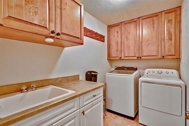 laundry room featuring a sink, cabinet space, and washer and clothes dryer