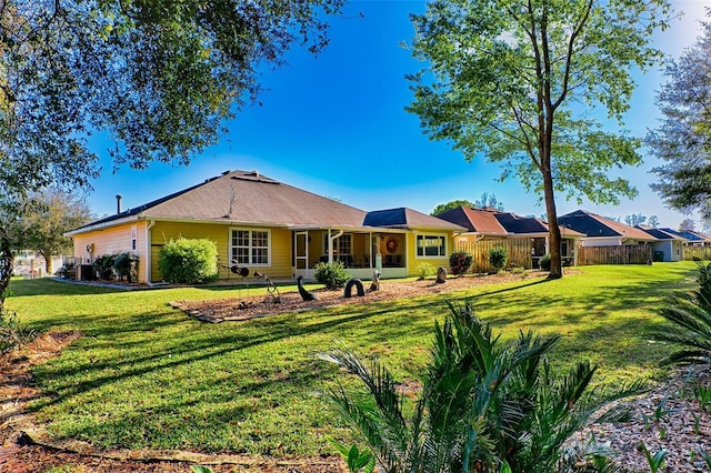 single story home featuring a front lawn and fence