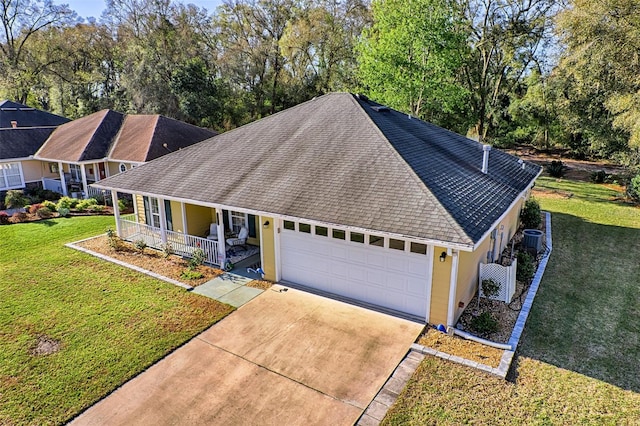 ranch-style house with a shingled roof, a porch, concrete driveway, a front yard, and central AC unit