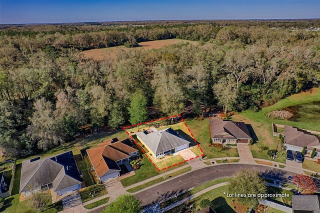 bird's eye view with a forest view and a residential view