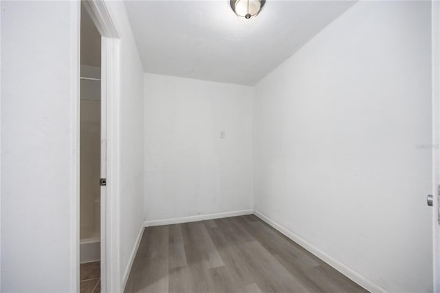 unfurnished room featuring baseboards and wood finished floors