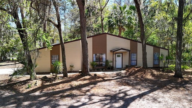 mid-century inspired home with driveway