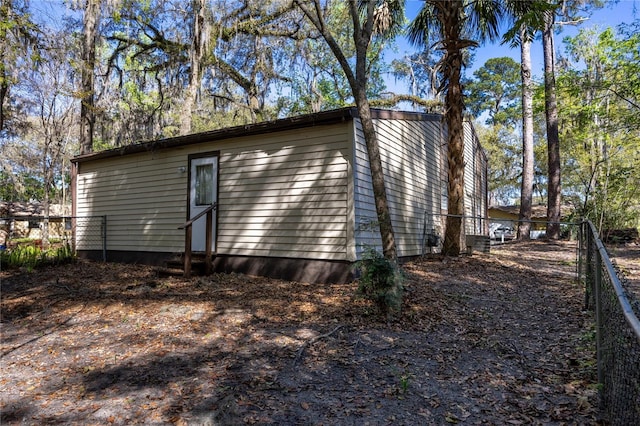 view of outbuilding with fence