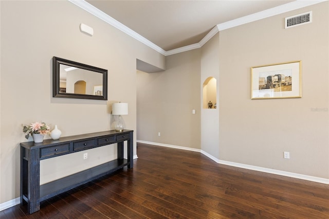 hall featuring visible vents, ornamental molding, baseboards, and hardwood / wood-style flooring