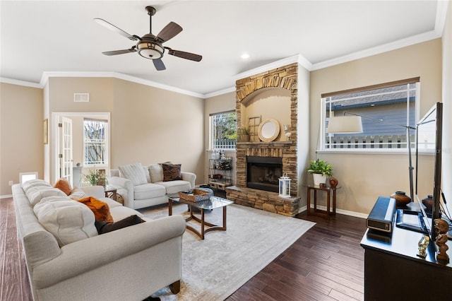 living area with visible vents, crown molding, baseboards, a ceiling fan, and dark wood-style flooring