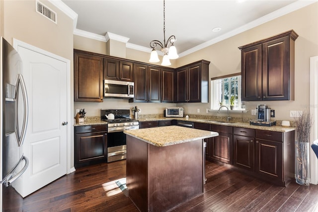 kitchen with dark wood finished floors, visible vents, stainless steel appliances, and a sink