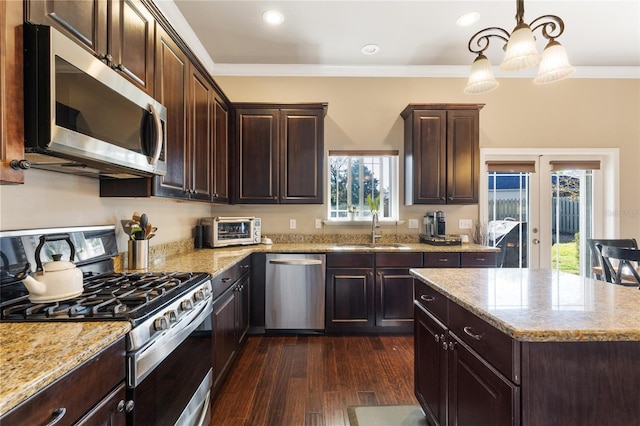 kitchen featuring ornamental molding, appliances with stainless steel finishes, dark wood-type flooring, and a sink