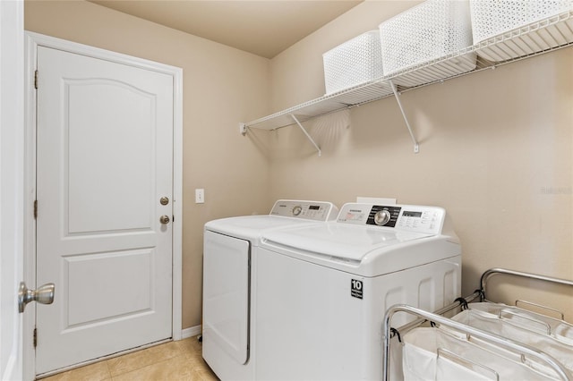 laundry room with light tile patterned flooring, laundry area, and washing machine and dryer