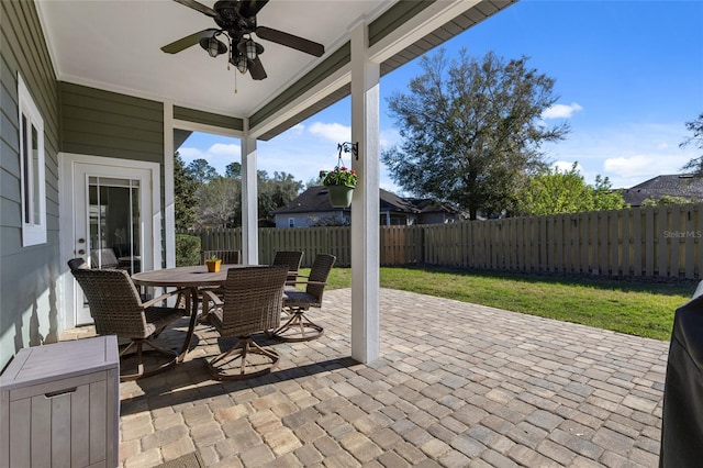 view of patio with a fenced backyard, ceiling fan, and outdoor dining space