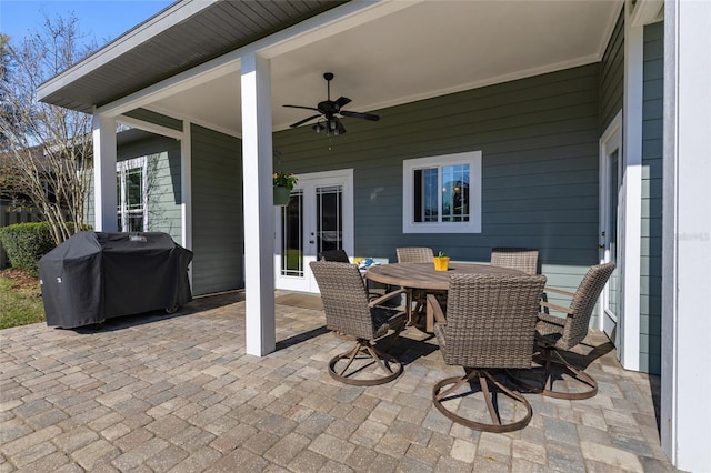 view of patio with ceiling fan, outdoor dining space, french doors, and a grill