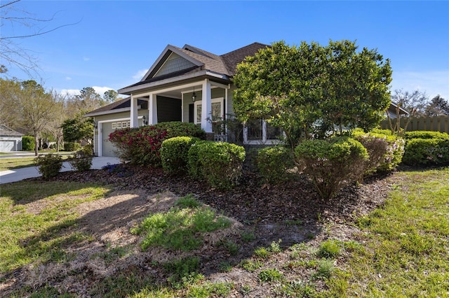 view of front of home with covered porch, driveway, and a garage