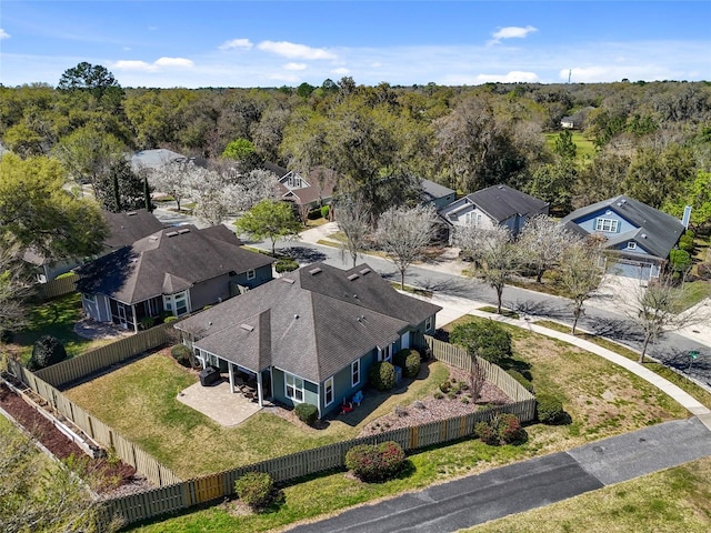 birds eye view of property featuring a forest view and a residential view