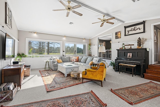 carpeted living room with vaulted ceiling with beams, visible vents, a wealth of natural light, and wainscoting