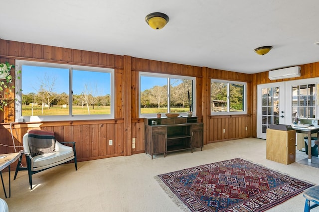 office featuring french doors, wood walls, carpet floors, and a wall mounted AC