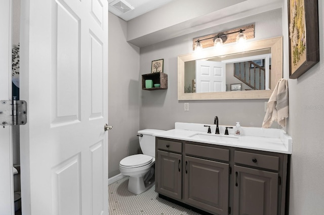 bathroom with vanity, tile patterned floors, toilet, and visible vents