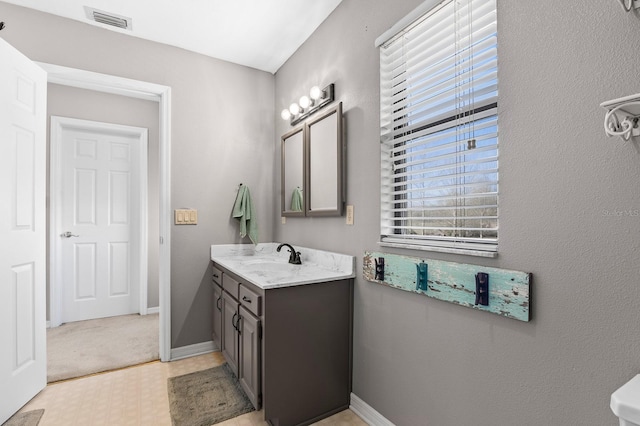 bathroom with tile patterned floors, visible vents, vanity, and baseboards