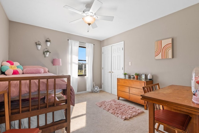 bedroom with a closet, light colored carpet, and ceiling fan