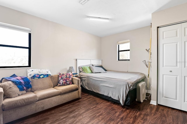 bedroom featuring wood finished floors and visible vents