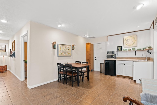 dining space with light tile patterned floors, recessed lighting, and baseboards