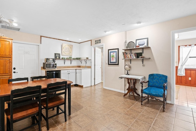 dining room with light tile patterned floors, visible vents, and baseboards