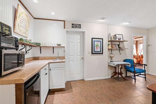 kitchen with stainless steel microwave, a sink, light countertops, and open shelves