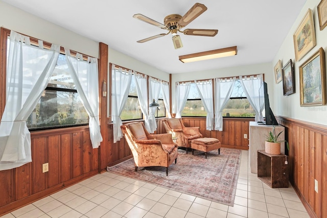 sunroom / solarium featuring ceiling fan