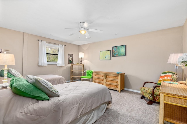 carpeted bedroom featuring baseboards and a ceiling fan