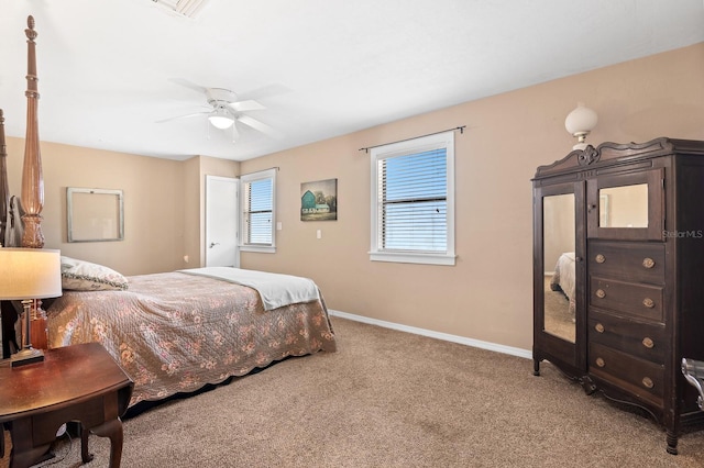 carpeted bedroom featuring visible vents, a ceiling fan, and baseboards