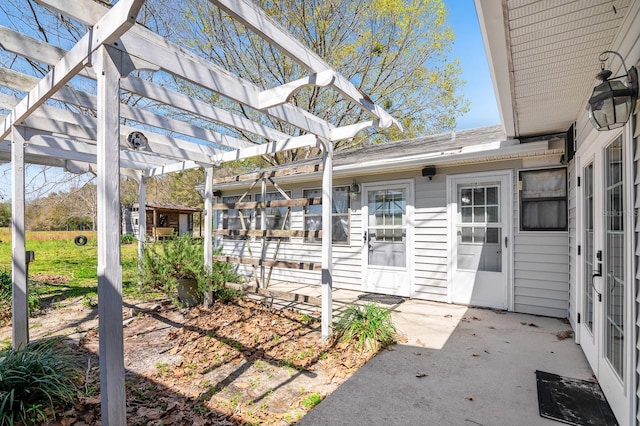 entrance to property with a patio area and a pergola