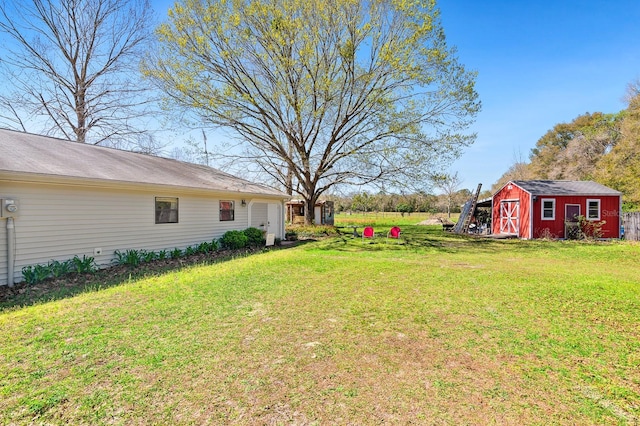 view of yard featuring an outbuilding and a shed