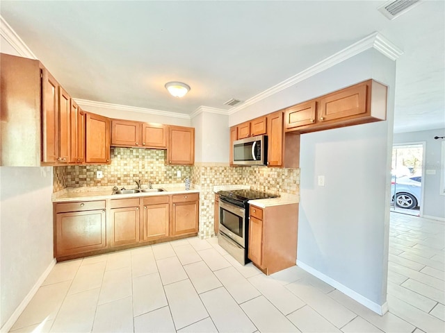 kitchen with visible vents, a sink, stainless steel appliances, light countertops, and backsplash