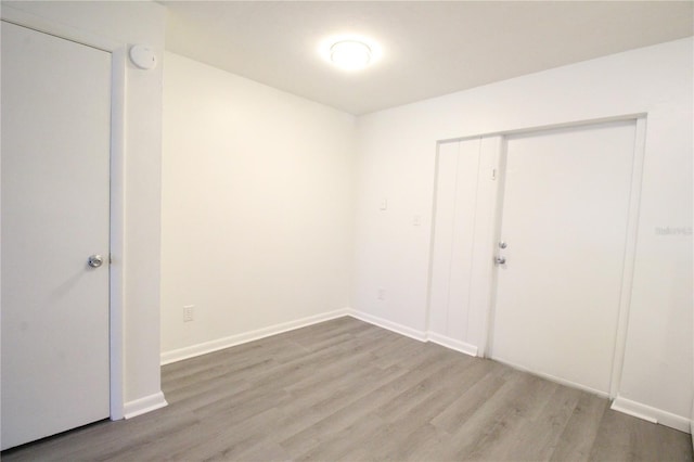 empty room featuring baseboards and wood finished floors