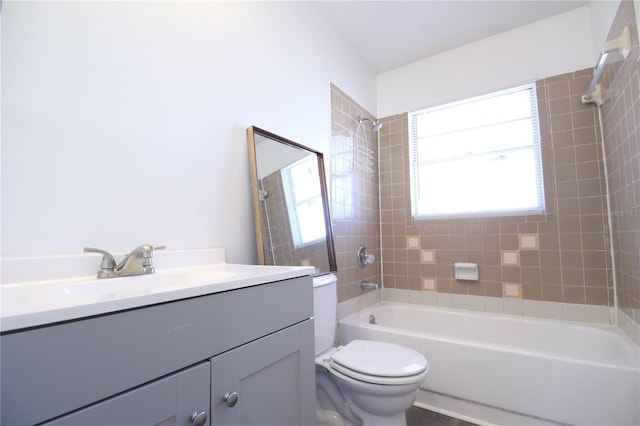 bathroom featuring shower / bathtub combination, toilet, and vanity