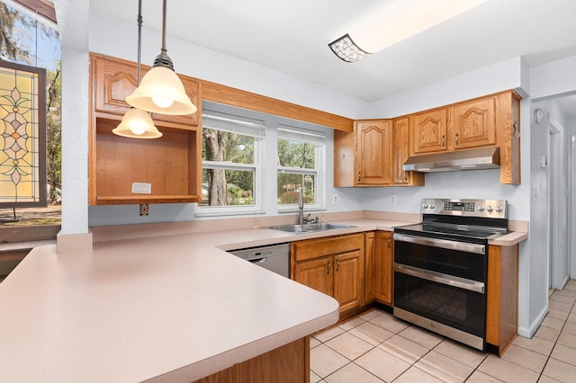 kitchen with under cabinet range hood, appliances with stainless steel finishes, light countertops, and a sink